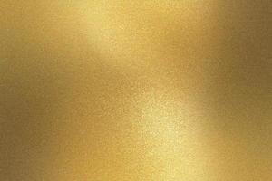 Glowing gold metallic wall surface, abstract background photo