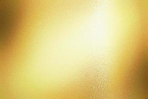 Light shining on gold foil glitter metallic wall with copy space, abstract texture background photo