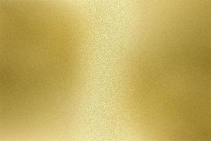 Light shining on rough gold metal wall texture, abstract background photo