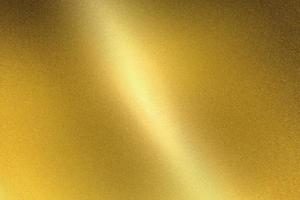 Light shining on gold metal sheet, abstract texture background