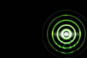 Abstract green light ring effect with sound waves oscillating on black background photo