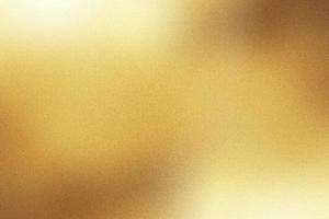 Light shining down on gold foil metal wall with copy space, abstract background photo