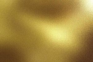 Glowing brushed gold metal wall surface, abstract texture background photo