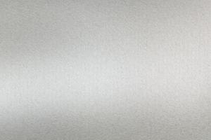 Brushed silver metallic wall with scratched surface, abstract texture background photo