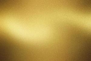 Shiny brushed golden metal wall, abstract texture background photo