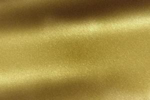 Light shining on brushed gold metal sheet, abstract texture background photo