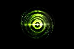 Glowing light green vortex on black backdrop, abstract background photo