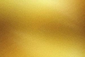 Brushed golden metal foil surface, abstract texture background photo