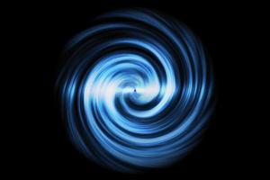 Glowing spiral tunnel with light blue cloud on black background photo