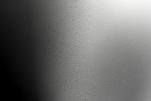 Texture of rough gray metallic wall in dark room, abstract background photo