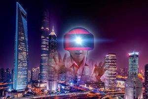 Defocus overlapping image of a man wearing virtual reality glasses and a modern building. Metaverse digital cyber technology concept. Future digital technology cyber virtual game entertainment. photo