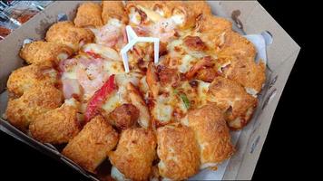 Pizza with seafood and cheese bacon on pizza box photo