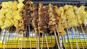Squid skewers for grilling Thai street food delicious photo