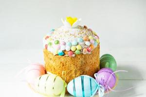 Easter cake with painted eggs on a platter in a gray interior. Traditional festive food photo