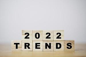 2022 on wooden cube block with trend wording for new year fashion trend and business change concept. photo