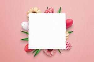 Blank paper surrounded with Easter eggs and decorations for promo greeting text photo