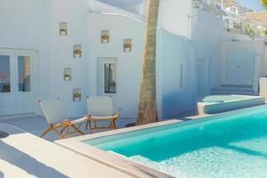 Luxury travel vacation landscape with infinity pool, swimming pool with sea view. White architecture on Santorini island, Greece. Summer relax recreational view photo