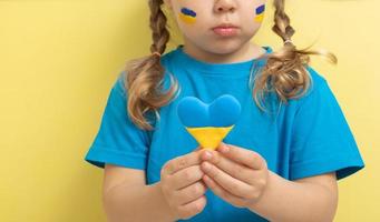 la chica tiene un corazón de color amarillo y azul de la bandera ucraniana foto