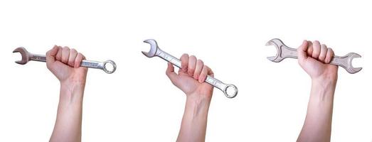 A collage of hands with wrenches on a white background. photo
