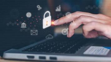 Cyber security online concept. The businessman touches his finger on the lock icon. Connect to a network, internet, personal data, and protection. Password and intelligence technology. photo