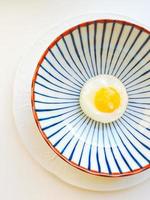 Egg white with yellow on a plate with blue decor photo