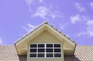 Roof window on blue sky background photo