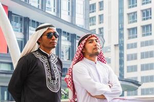 Two Arab Middle Eastern business man walking in downtown