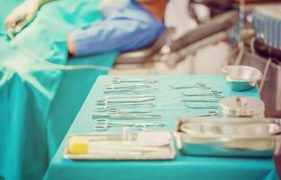 Surgical instruments and tools including scalpels, forceps and tweezers arranged on a table for a surgery, operating room with surgery equipment, preparing medical instruments for operation photo