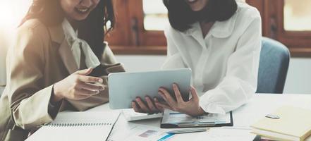 Group of business consultant working by digital tablet and management big data and analyze financial document of company. photo
