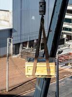 The crane lifting the radioactive instrument holder transportation wooden box photo