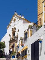 ESTEPONA, ANDALUCIA, SPAIN, 2014.  Church of Nuestra Senora de los Remedios in Estepona Spain on May 5, 2014. Two unidentified people. photo