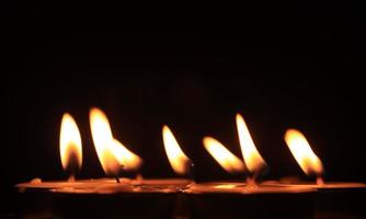 Candle flame on a black background religious ceremony photo