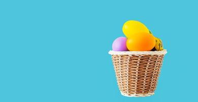 basket of easter eggs on  blue background photo