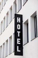 vertical hotel sign on generic modern city hotel facade photo