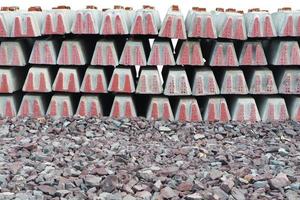 Concrete Railway sleepers stacked on crushed stone isolated on white background with clipping path. photo