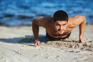 Strong attractive runner is pushed from the floor before morning photo