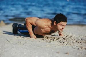 Strong attractive runner is pushed from the floor before morning photo