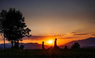 village silhouette at sunset photo