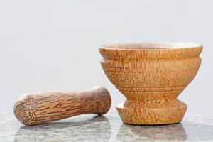 Pestle and mortar made of coconut tree photo