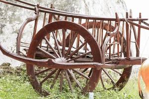 The wood wheel of a cart or buckboard. photo