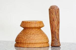 Pestle and mortar made of coconut tree photo