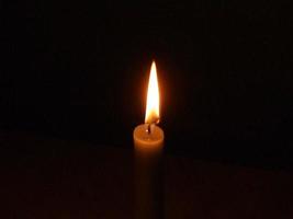 The flame of a lonely candle photo