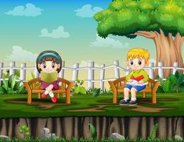 A smart boy and girl reading book in the park vector