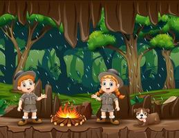 Two safari kids light a bonfire in the cave vector