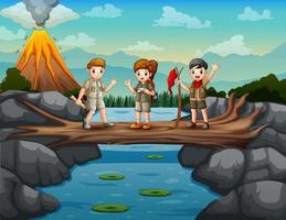 Scouts crossing the river on the tree trunk bridge vector