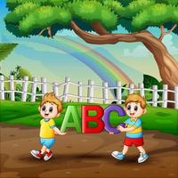 dibujos animados de dos niños sosteniendo la letra abc vector