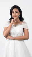Asian woman in white wedding dress. Thai bride poses before the wedding day. photo