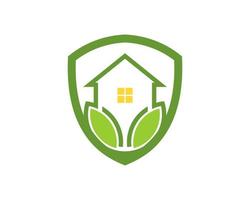 Shield with simple house and green nature leaf inside vector
