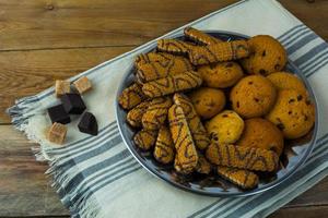 Various chip cookies on a wooden background photo