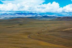 Road stretches into the distance across the steppe photo